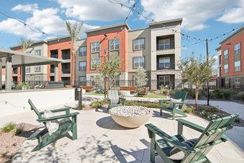 our apartments offer a patio with chairs and fire pit at The Maddox Luxury Apartment Homes, Buckeye, AZ